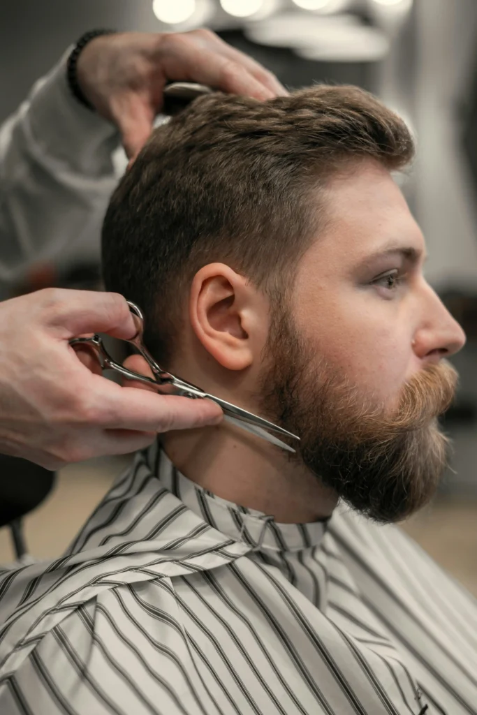 Bearded man getting his beard trimmed to maintain a rugged and well-groomed style