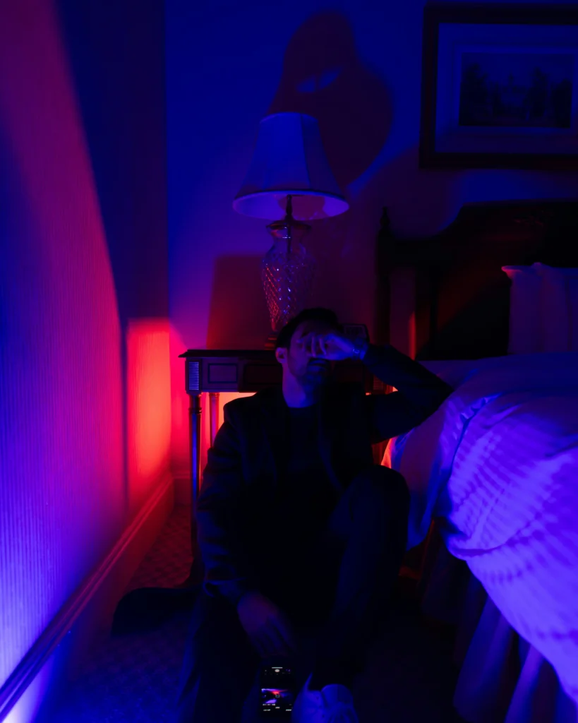 Sleep and recovery for men – man exhausted at night under artificial light
