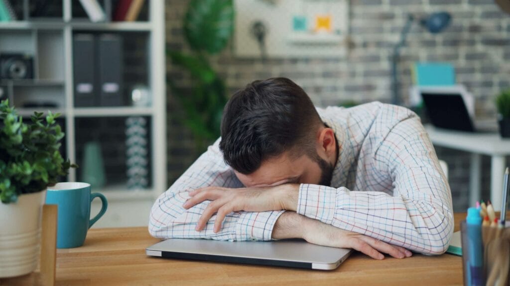 Sleep and recovery for men – exhausted man showing effects of poor sleep